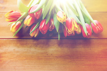 Image showing close up of tulip flowers on wooden table