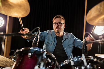 Image showing male musician playing drums and cymbals at concert