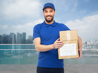 Image showing happy delivery man with boxes over singapore city