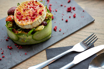 Image showing goat cheese salad with vegetables at restaurant