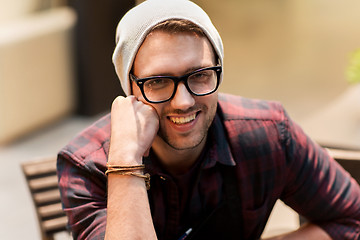 Image showing happy smiling man in eyeglasses and hipster hat