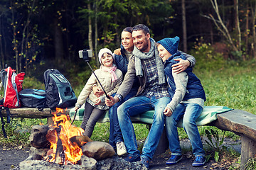 Image showing family with smartphone taking selfie near campfire