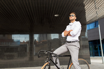 Image showing man with bicycle and headphones on city street