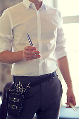 Image showing close up of male stylist with scissors at salon