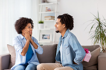 Image showing happy couple with gift box at home