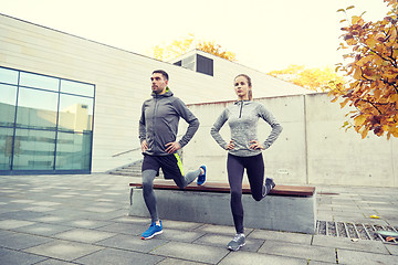 Image showing couple doing lunge exercise on city street