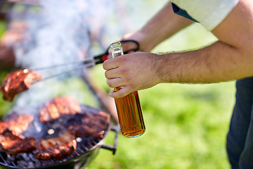Image showing man cooking meat on barbecue grill at summer party