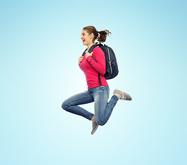 Image showing happy woman or student with backpack jumping