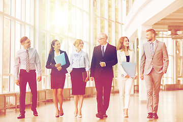 Image showing business people walking along office building