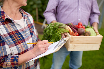 Image showing senior couple with box of vegetables at farm