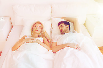 Image showing happy couple sleeping in bed at home