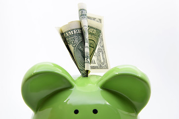 Image showing Green piggy bank with US dollar bills