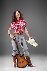 Image showing The cowgirl fashion woman over a gray background