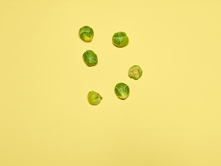 Image showing The piles of Brussels sprouts on a yellow background