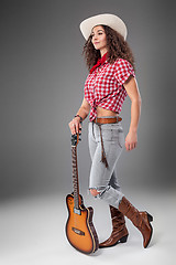 Image showing The cowgirl fashion woman over a gray background