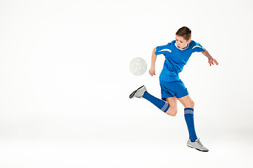 Image showing Young boy with soccer ball doing flying kick