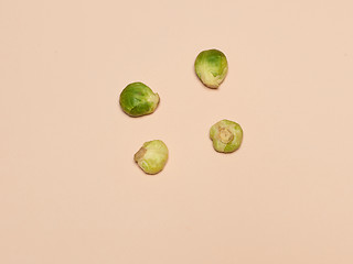 Image showing The piles of Brussels sprouts on a pink background