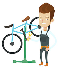 Image showing Caucasian bicycle mechanic working in repair shop.