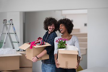 Image showing multiethnic couple moving into a new home