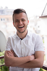 Image showing man standing at balcony