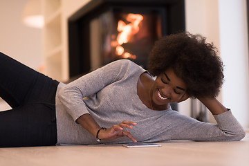 Image showing black women used tablet computer on the floor