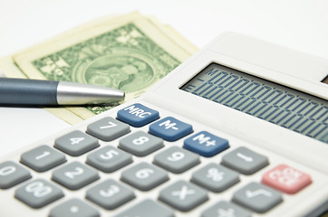 Image showing Calculator, money and pen isolated on white