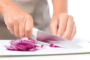 Image showing Cook is chopping onion