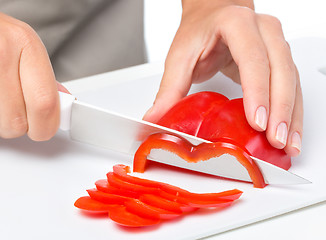 Image showing Cook is chopping bell pepper