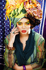 Image showing beauty bright woman with creative make up, many shawls on head l