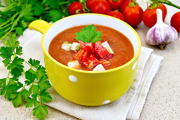 Image showing Soup tomato in yellow bowl on granite table