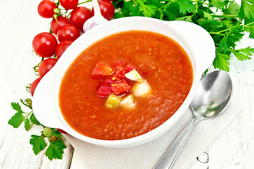 Image showing Soup tomato in white bowl with vegetables on board