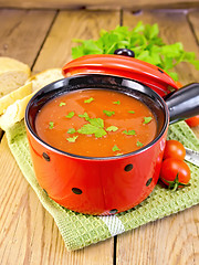 Image showing Soup tomato in red bowl on board