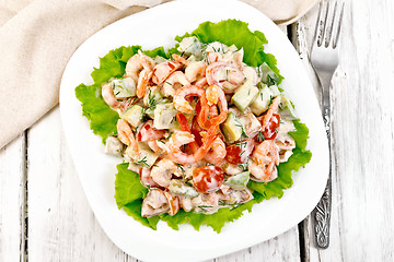 Image showing Salad with shrimp and avocado in plate on board top