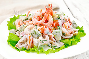 Image showing Salad with shrimp and avocado in white plate on board