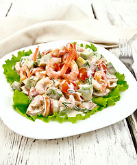 Image showing Salad with shrimp and tomatoes in white plate on board