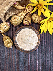 Image showing Flour of Jerusalem artichoke in clay bowl on board top