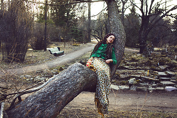 Image showing Young cute smiling real stylish dressed woman in green palm park