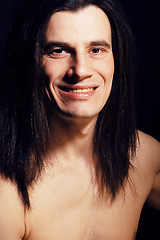 Image showing handsome young man with long hair naked torso on black backgroun