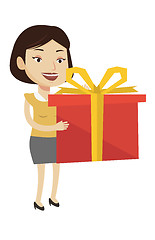 Image showing Joyful caucasian woman holding box with gift.