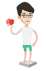 Image showing Man standing on scale and holding apple in hand.