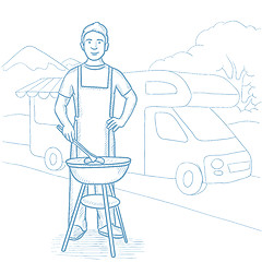 Image showing Man having barbecue in front of camper van.