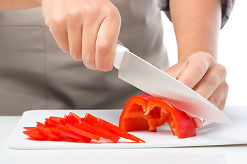 Image showing Cook is chopping bell pepper