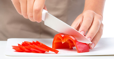 Image showing Cook is chopping bell pepper