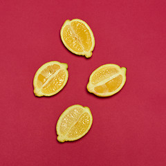 Image showing Lemons on red background