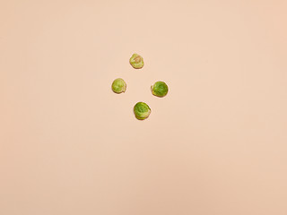 Image showing The piles of Brussels sprouts on a pink background