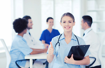 Image showing happy doctor over group of medics at hospital