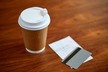 Image showing coffee in paper cup, bill and credit card on table