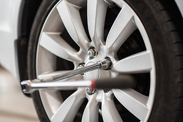 Image showing screwdriver and car wheel tire