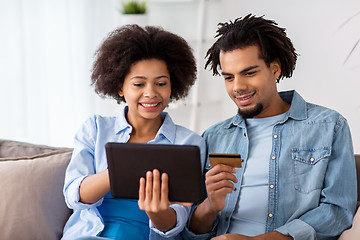 Image showing couple with tablet pc and credit card at home