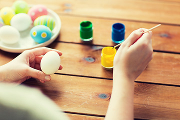 Image showing close up of woman coloring easter eggs